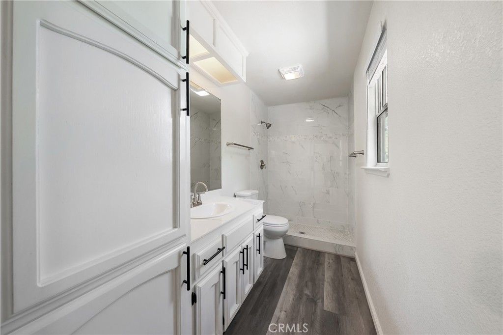 Bathroom, Dual Sink Vanities, Glass Shower, Interior, Marble Walls, Wood Texture Flooring