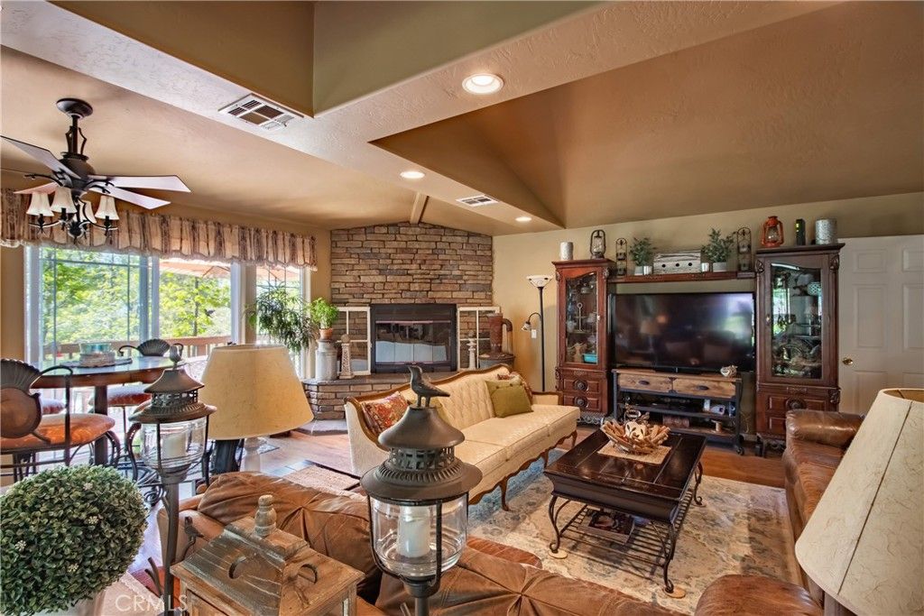 Dining room, Fireplace, Interior, Living room, Recessed Lighting, Stone Walls, Wood Texture Flooring