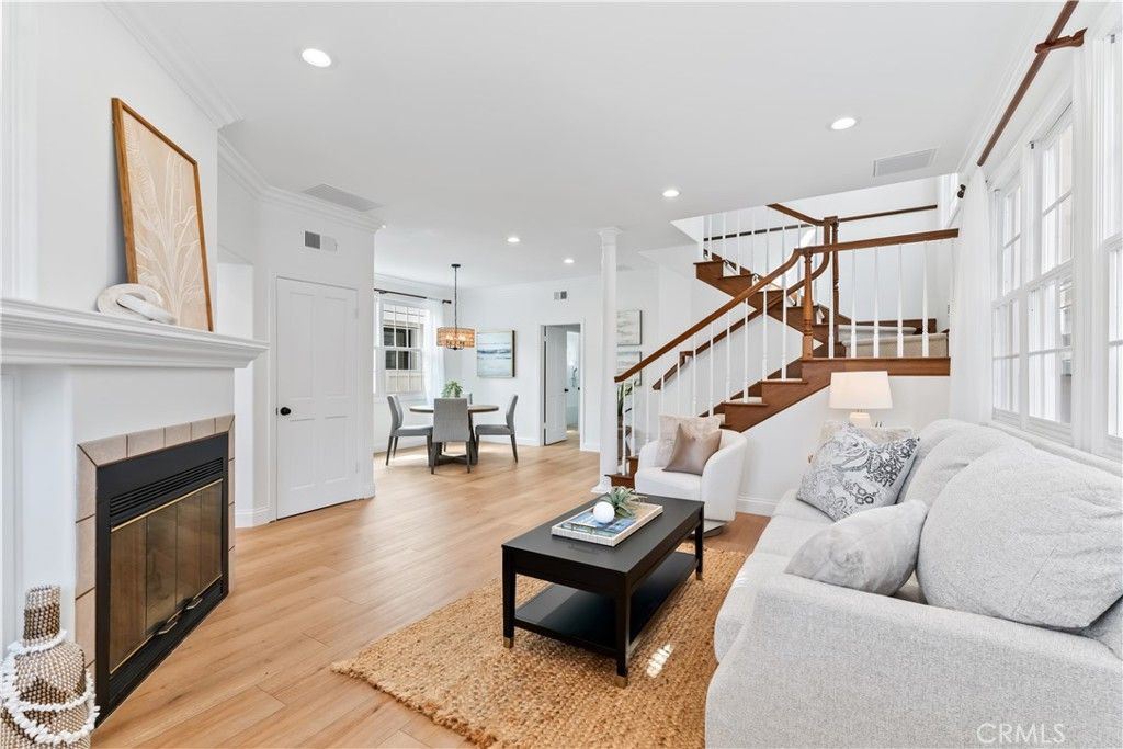 Chandelier, Dining room, Fireplace, Interior, Living room, Pendant Lights, Recessed Lighting, Wood Texture Flooring