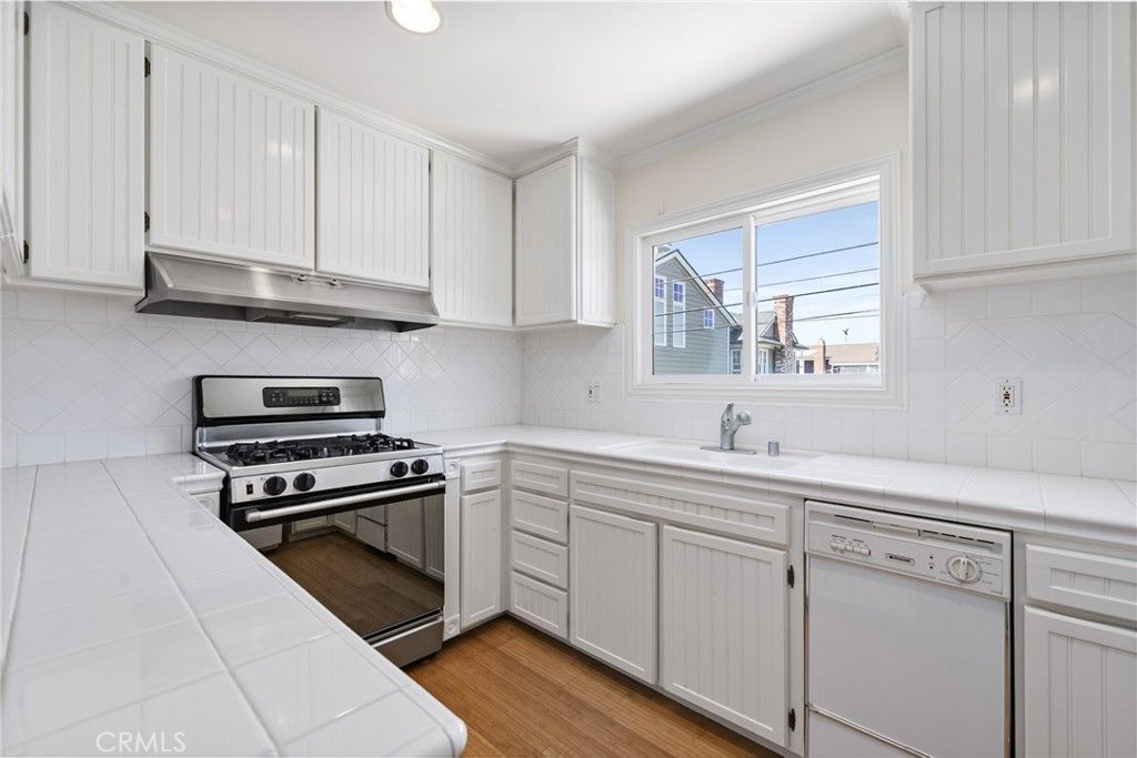 Interior, Kitchen, Recessed Lighting, Stainless Steel Appliances, Tile Countertops, Wood Texture Flooring