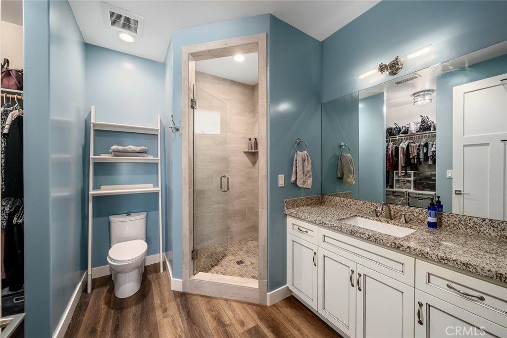 Bathroom, Dual Sink Vanities, Glass Shower, Interior, Recessed Lighting, Walk-in Closets, Wood Texture Flooring