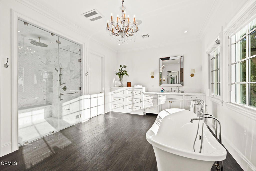Bathroom, Chandelier, Dual Sink Vanities, Free Standing Baths, Glass Shower, Interior, Marble Walls, Recessed Lighting, Wood Texture Flooring