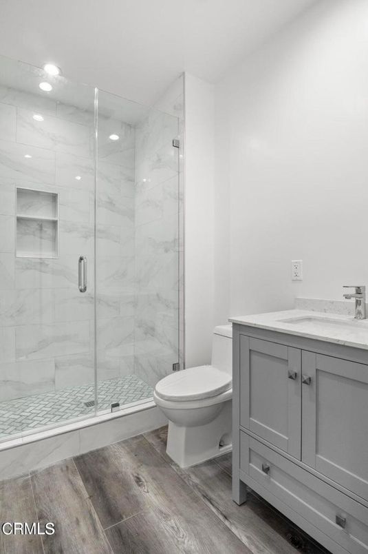 Bathroom, Glass Shower, Interior, Marble Walls, Recessed Lighting, Wood Texture Flooring