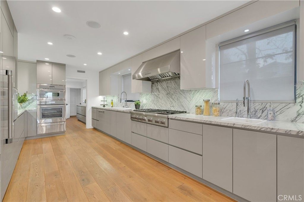 Interior, Kitchen, Marble Walls, Recessed Lighting, Stainless Steel Appliances, Wood Texture Flooring