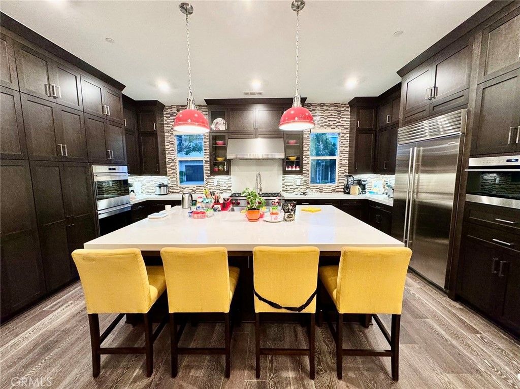 Interior, Kitchen, Pendant Lights, Recessed Lighting, Stainless Steel Appliances, Stone Walls, Wood Texture Flooring