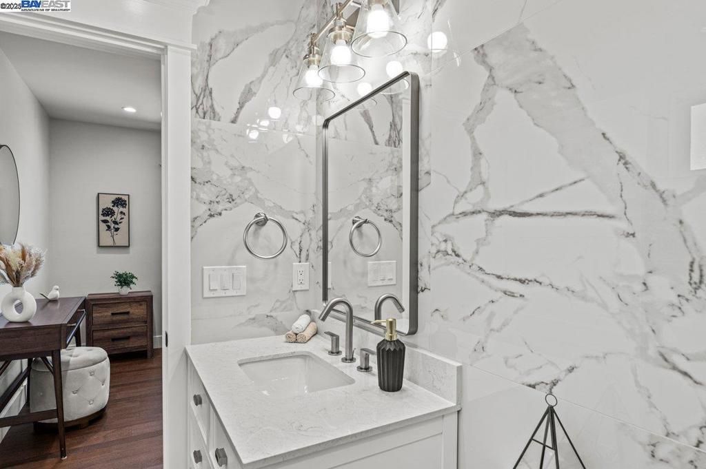 Bathroom, Dual Sink Vanities, Interior, Marble Walls, Recessed Lighting, Wood Texture Flooring