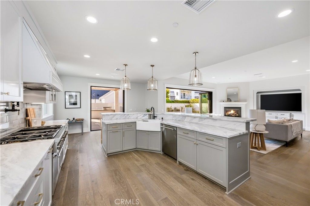 Fireplace, Interior, Kitchen, Living room, Pendant Lights, Recessed Lighting, Stainless Steel Appliances, Wood Texture Flooring