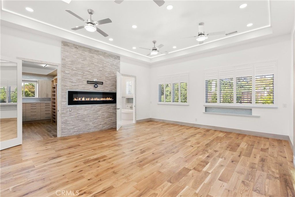 Empty room, Fireplace, Interior, Recessed Lighting, Stone Walls, Wood Texture Flooring