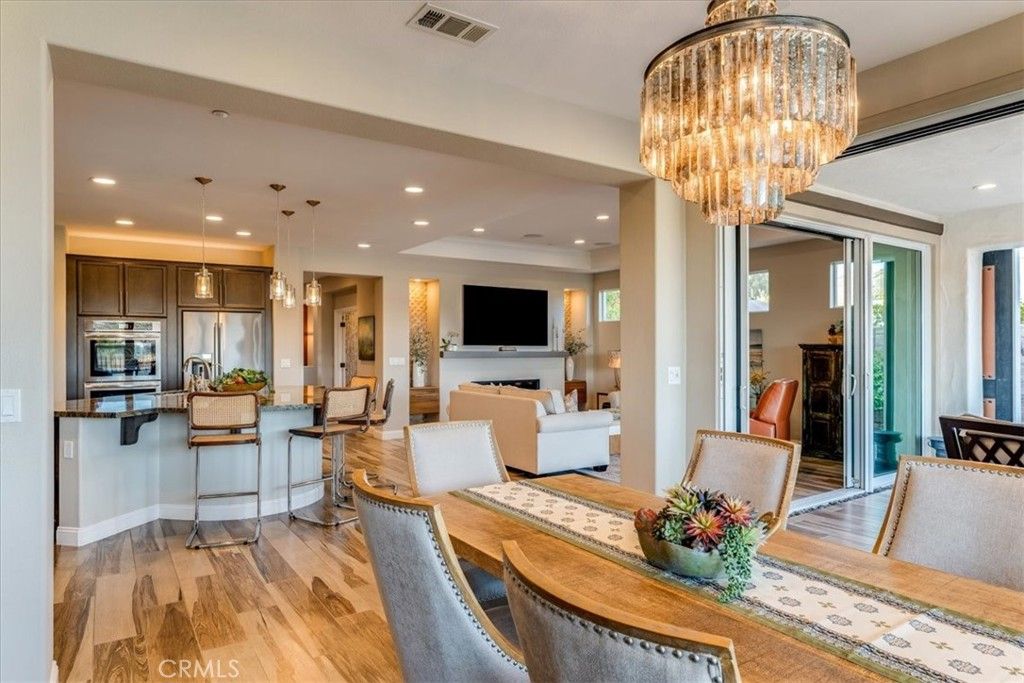 Chandelier, Dining room, Interior, Kitchen, Living room, Pendant Lights, Recessed Lighting, Stainless Steel Appliances, Wood Texture Flooring