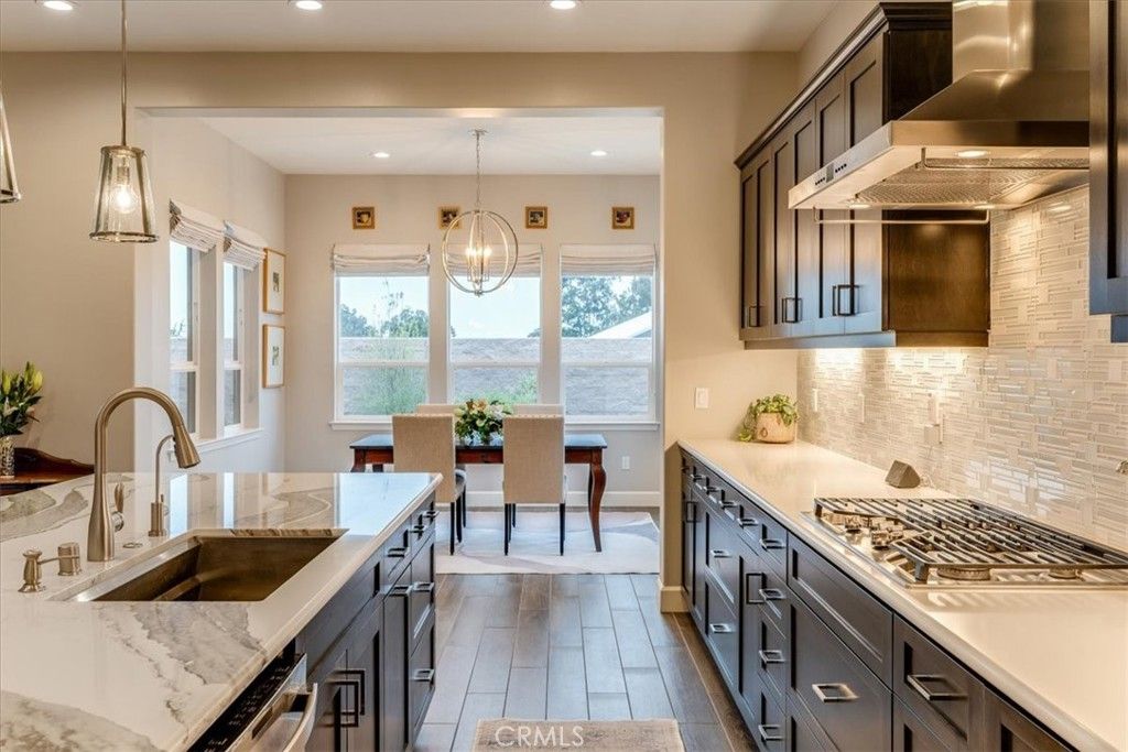 Chandelier, Dining room, Interior, Kitchen, Pendant Lights, Recessed Lighting, Stainless Steel Appliances, Wood Texture Flooring