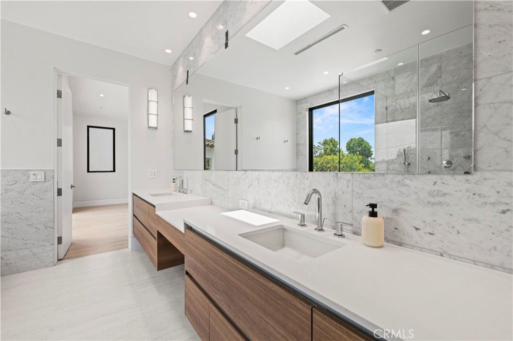 Bathroom, Dual Sink Vanities, Glass Shower, Interior, Marble Walls, Recessed Lighting, Wood Texture Flooring