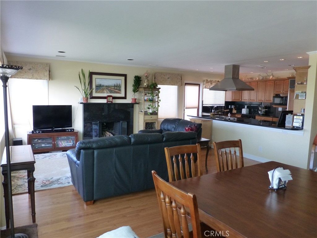 Dining room, Fireplace, Interior, Kitchen, Living room, Recessed Lighting, Stainless Steel Appliances, Wood Texture Flooring