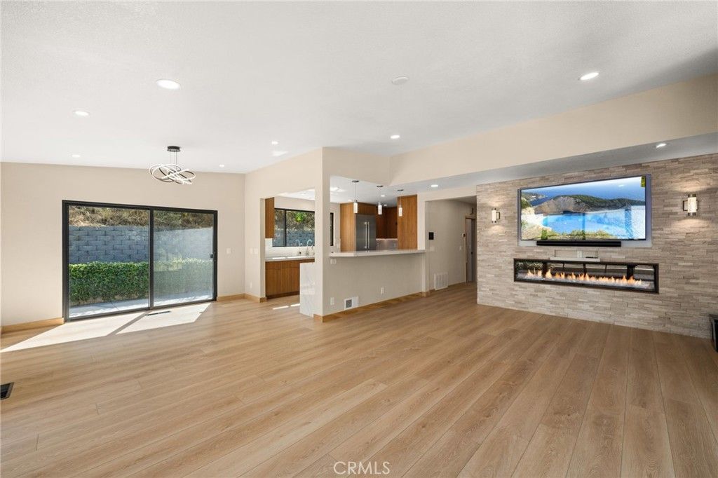 Empty room, Fireplace, Interior, Pendant Lights, Recessed Lighting, Stone Walls, Wood Texture Flooring