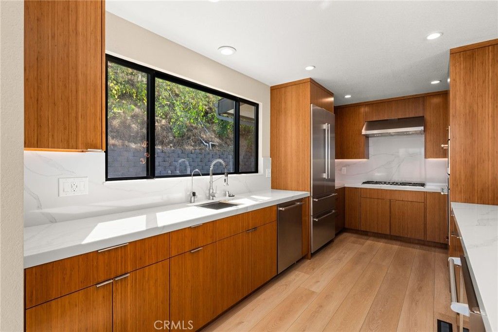 Interior, Kitchen, Marble Walls, Recessed Lighting, Stainless Steel Appliances, Wood Texture Flooring