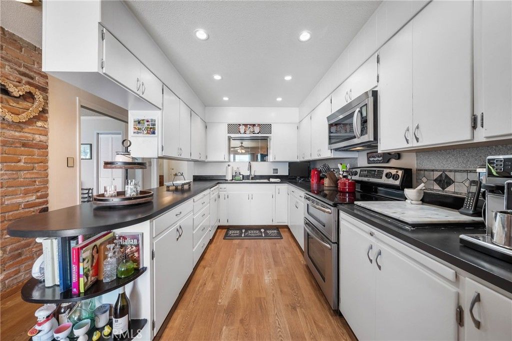 Interior, Kitchen, Recessed Lighting, Stainless Steel Appliances, Stone Walls, Wood Texture Flooring