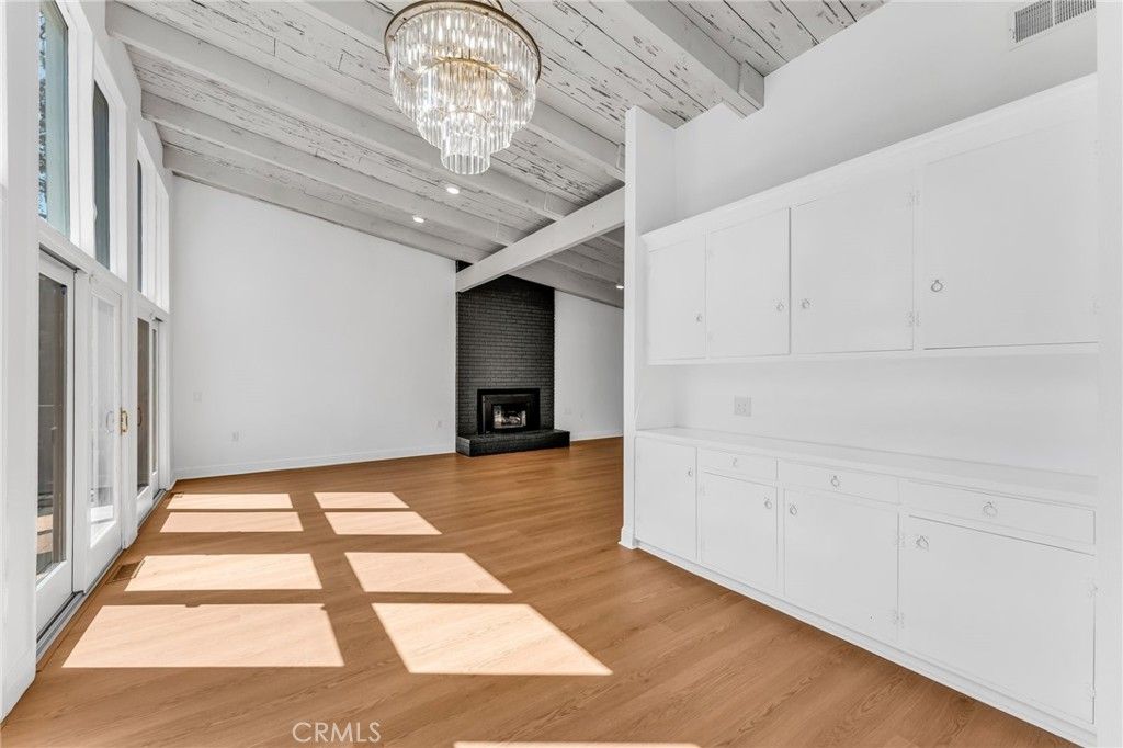 Chandelier, Empty room, Fireplace, Interior, Recessed Lighting, Stone Walls, Wood Texture Flooring