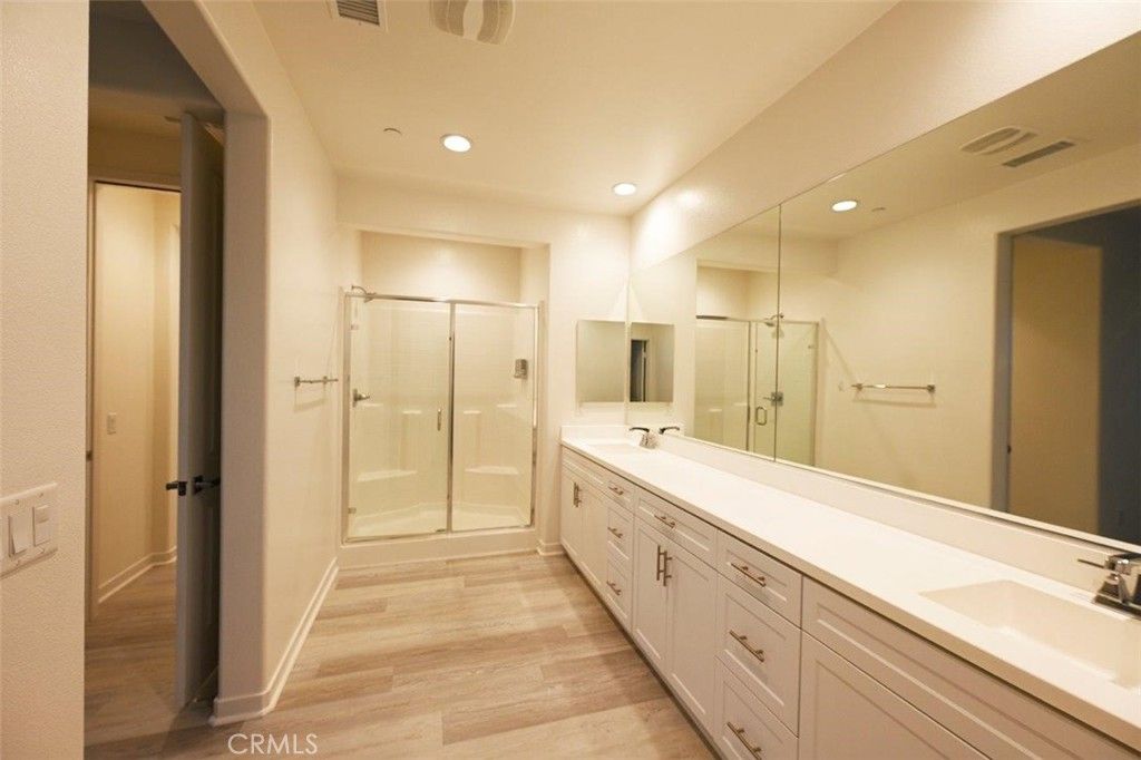 Bathroom, Dual Sink Vanities, Glass Shower, Interior, Recessed Lighting, Wood Texture Flooring