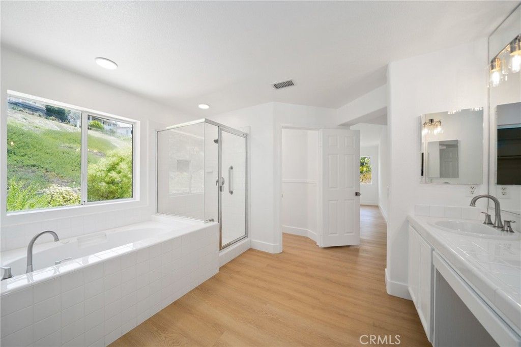 Bathroom, Dual Sink Vanities, Glass Shower, Interior, Recessed Lighting, Wood Texture Flooring