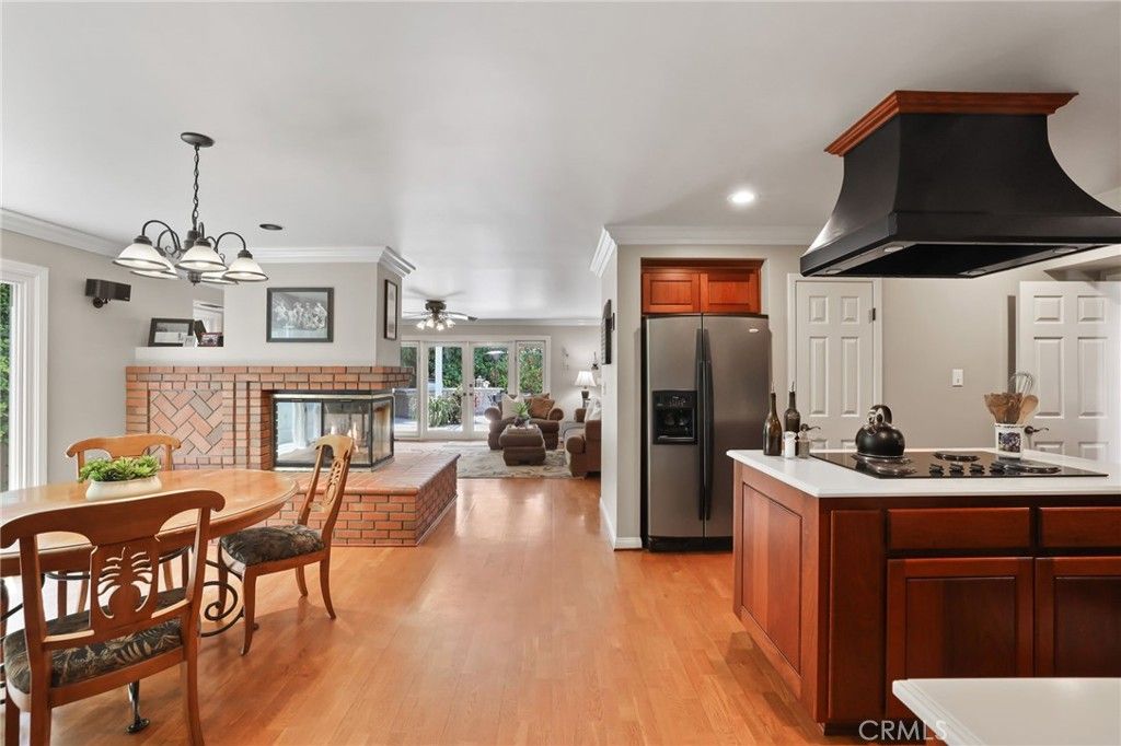Chandelier, Dining room, Fireplace, Interior, Kitchen, Living room, Pendant Lights, Recessed Lighting, Stainless Steel Appliances, Wood Texture Flooring