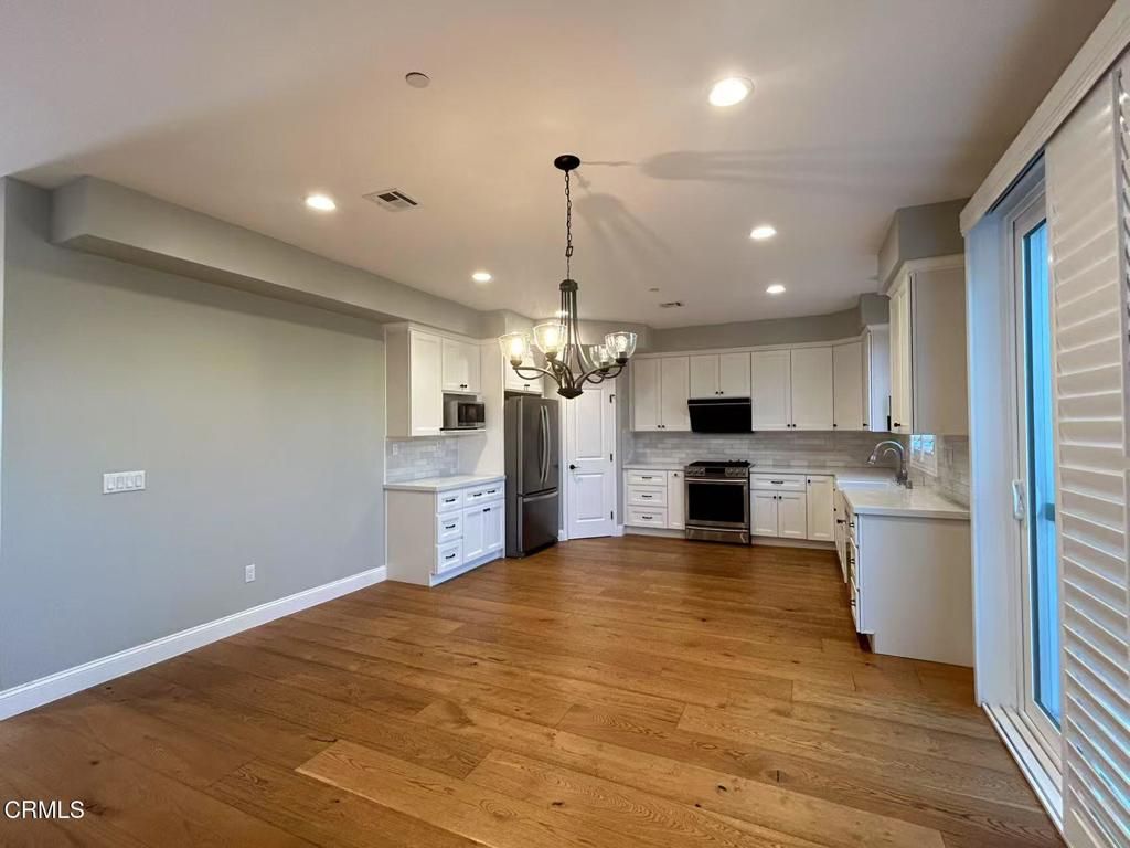 Chandelier, Interior, Kitchen, Recessed Lighting, Stainless Steel Appliances, Wood Texture Flooring
