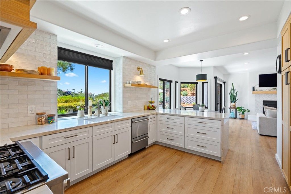 Fireplace, Interior, Kitchen, Pendant Lights, Recessed Lighting, Stainless Steel Appliances, Stone Walls, Wood Texture Flooring