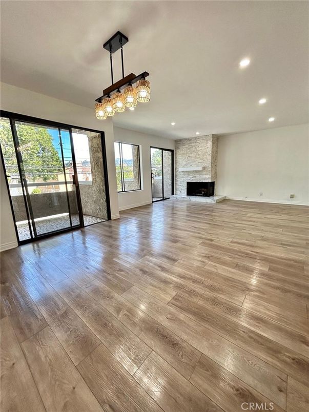 Chandelier, Empty room, Fireplace, Interior, Recessed Lighting, Wood Texture Flooring