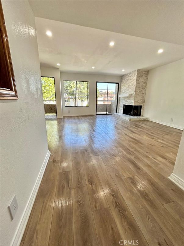 Empty room, Fireplace, Interior, Recessed Lighting, Stone Walls, Wood Texture Flooring