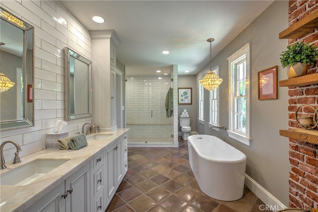 Bathroom, Chandelier, Dual Sink Vanities, Free Standing Baths, Glass Shower, Interior, Pendant Lights, Recessed Lighting, Stone Walls