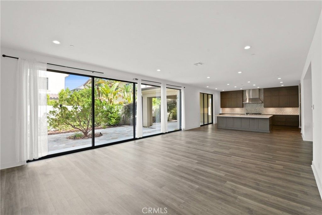 Empty room, Interior, Kitchen, Recessed Lighting, Stainless Steel Appliances, Wood Texture Flooring