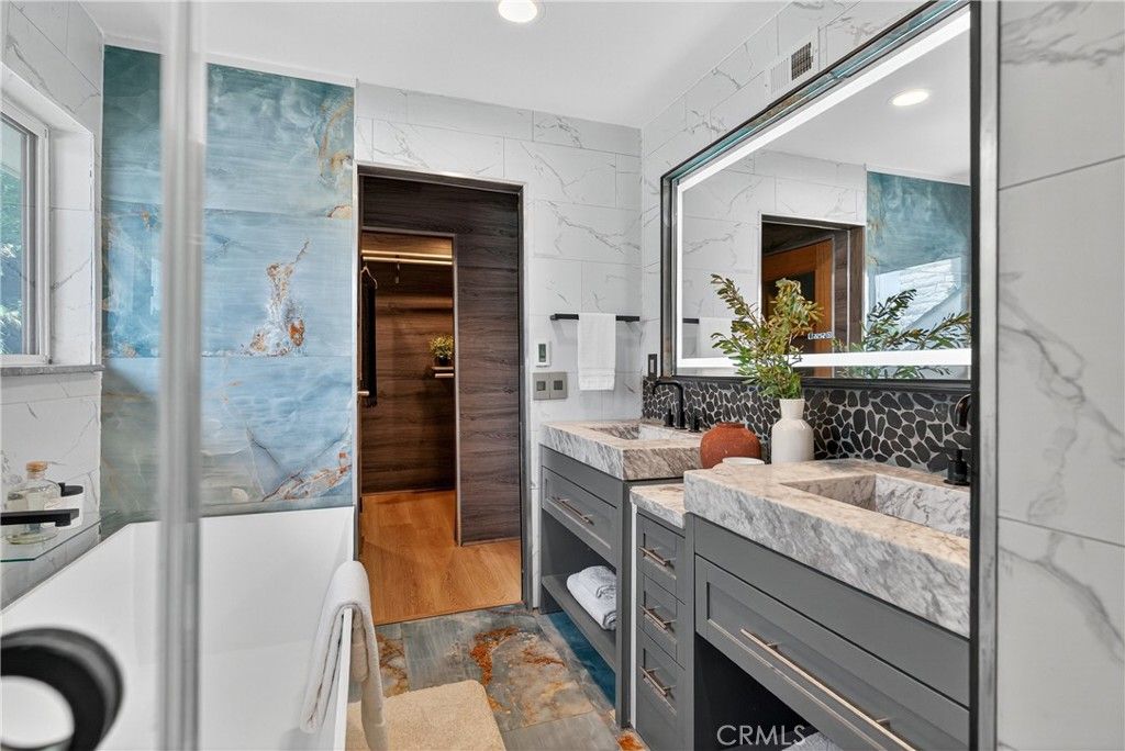 Bathroom, Dual Sink Vanities, Interior, Marble Walls, Recessed Lighting, Wood Texture Flooring