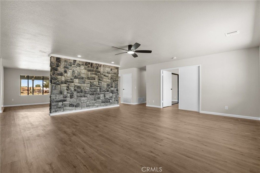 Empty room, Fireplace, Interior, Recessed Lighting, Stone Walls, Wood Texture Flooring