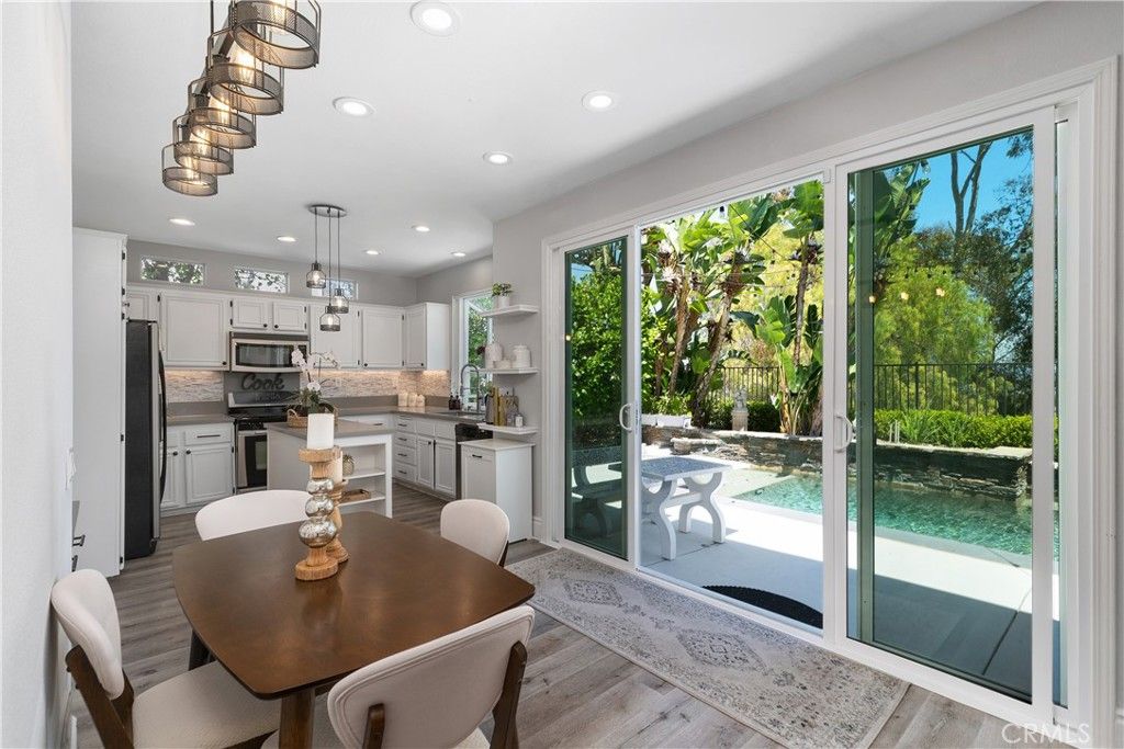 Dining room, Interior, Kitchen, Pendant Lights, Recessed Lighting, Stainless Steel Appliances, Wood Texture Flooring
