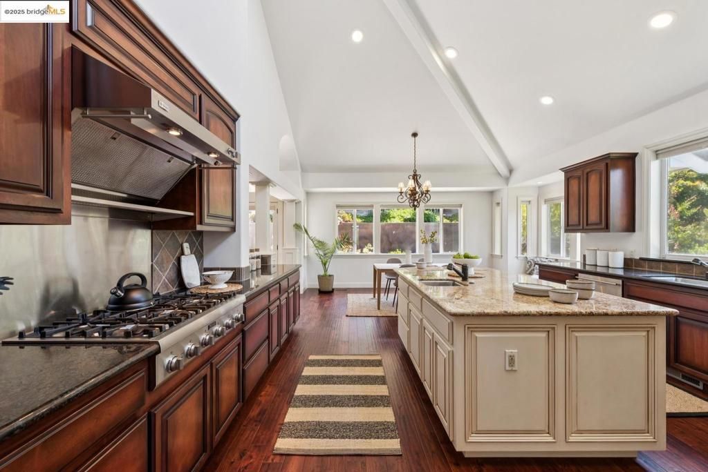 Chandelier, Dining room, Interior, Kitchen, Pendant Lights, Recessed Lighting, Stainless Steel Appliances, Wood Texture Flooring