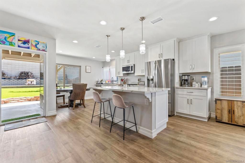 Dining room, Interior, Kitchen, Pendant Lights, Recessed Lighting, Stainless Steel Appliances, Wood Texture Flooring