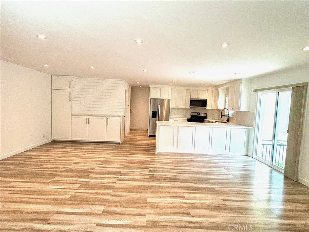 Empty room, Interior, Kitchen, Recessed Lighting, Stainless Steel Appliances, Wood Texture Flooring