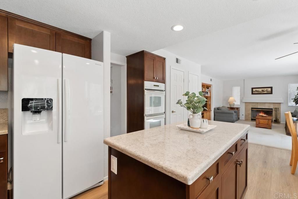 Fireplace, Interior, Kitchen, Living room, Recessed Lighting, Stainless Steel Appliances, Wood Texture Flooring