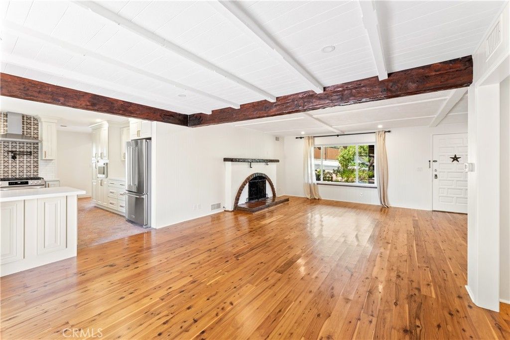 Empty room, Fireplace, Interior, Kitchen, Recessed Lighting, Stainless Steel Appliances, Wood Texture Flooring