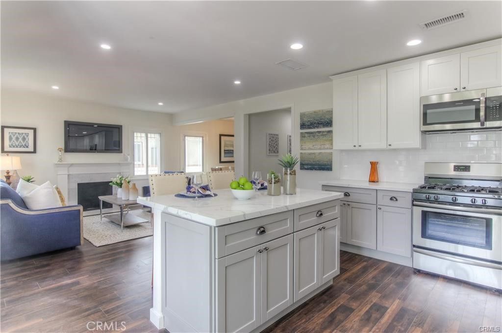Fireplace, Interior, Kitchen, Living room, Recessed Lighting, Stainless Steel Appliances, Wood Texture Flooring
