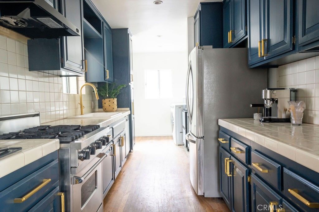 Interior, Kitchen, Recessed Lighting, Stainless Steel Appliances, Tile Countertops, Wood Texture Flooring