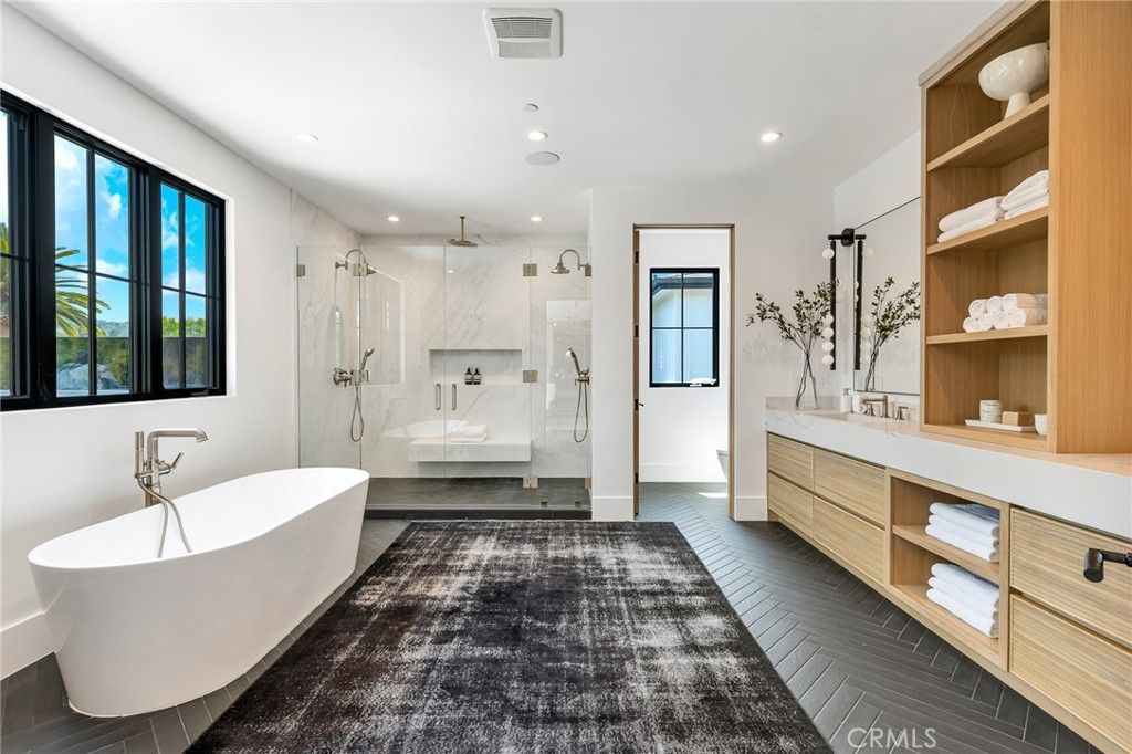 Bathroom, Dual Sink Vanities, Free Standing Baths, Glass Shower, Interior, Marble Walls, Recessed Lighting, Wood Texture Flooring