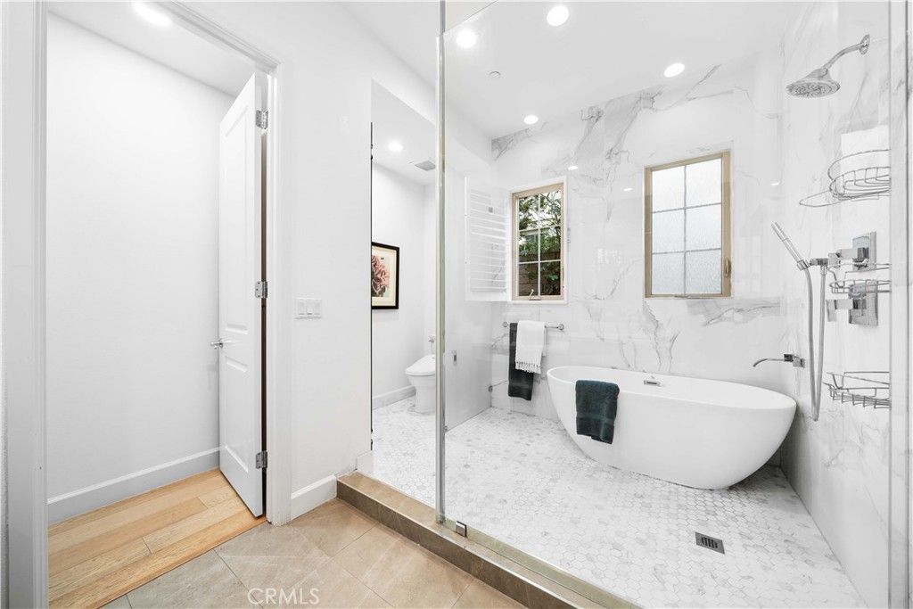 Bathroom, Free Standing Baths, Glass Shower, Interior, Marble Walls, Recessed Lighting, Wood Texture Flooring