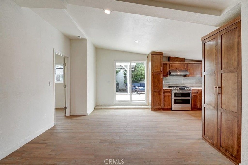 Empty room, Interior, Kitchen, Recessed Lighting, Stainless Steel Appliances, Wood Texture Flooring