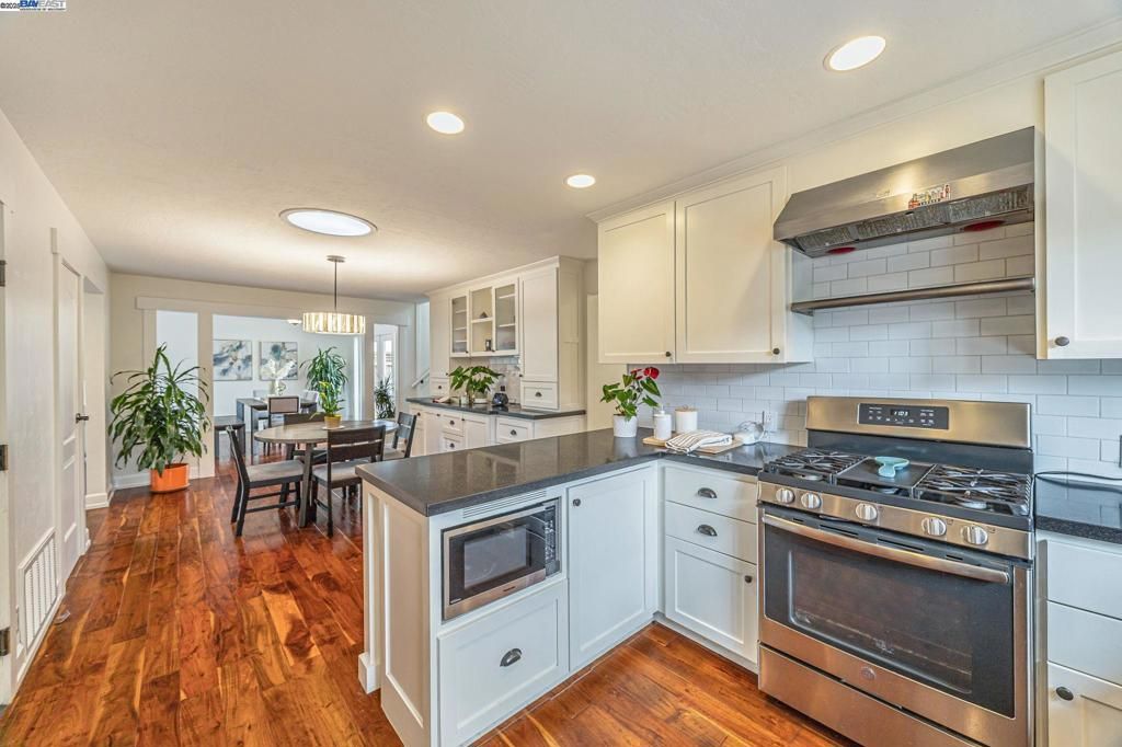 Chandelier, Dining room, Interior, Kitchen, Recessed Lighting, Stainless Steel Appliances, Wood Texture Flooring