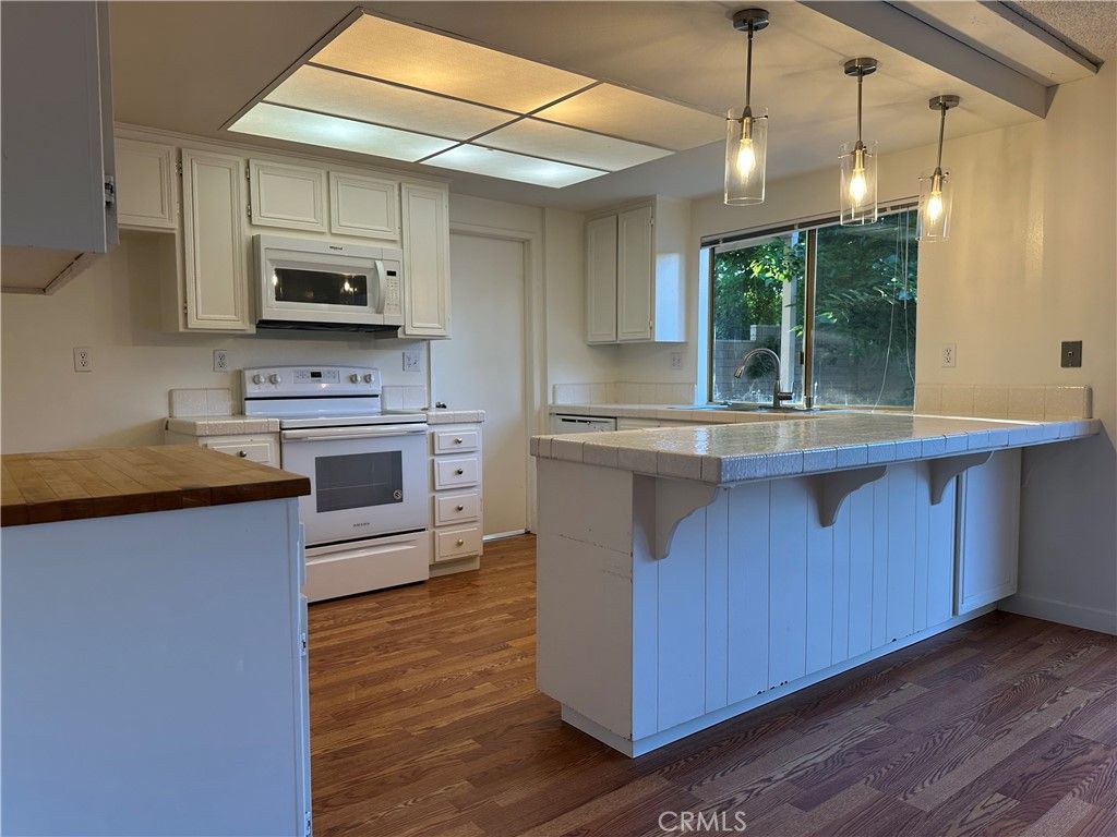 Interior, Kitchen, Pendant Lights, Tile Countertops, Wood Texture Flooring