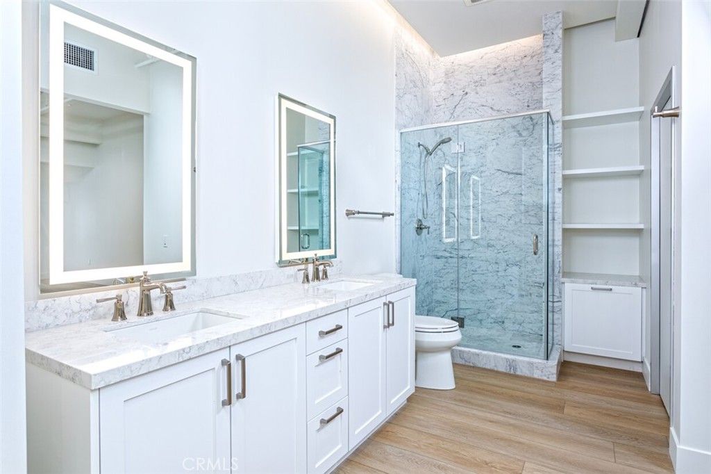 Bathroom, Dual Sink Vanities, Glass Shower, Interior, Marble Walls, Wood Texture Flooring
