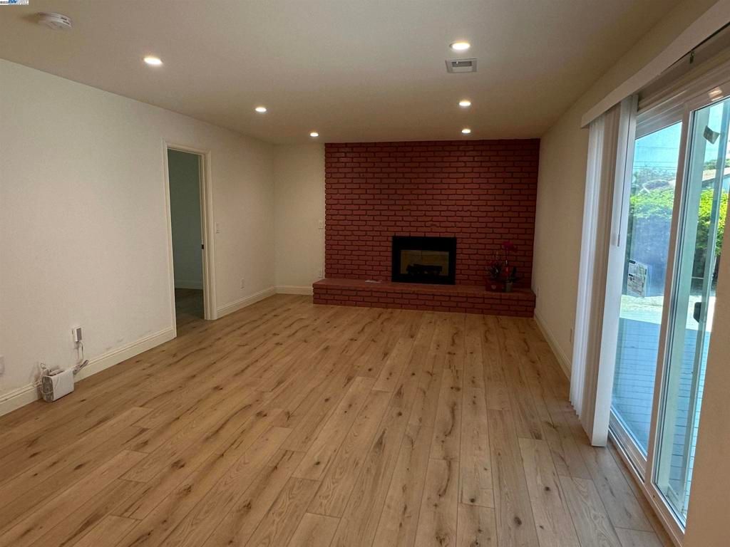 Empty room, Fireplace, Interior, Recessed Lighting, Stone Walls, Wood Texture Flooring