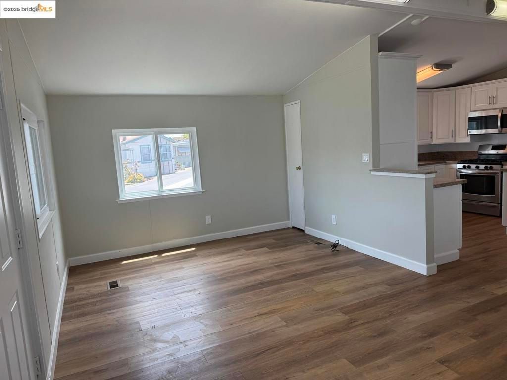 Empty room, Interior, Kitchen, Stainless Steel Appliances, Wood Texture Flooring