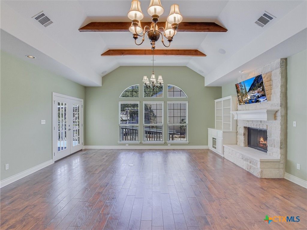 Chandelier, Empty room, Fireplace, Interior, Recessed Lighting, Wooden Beams, Wood Texture Flooring