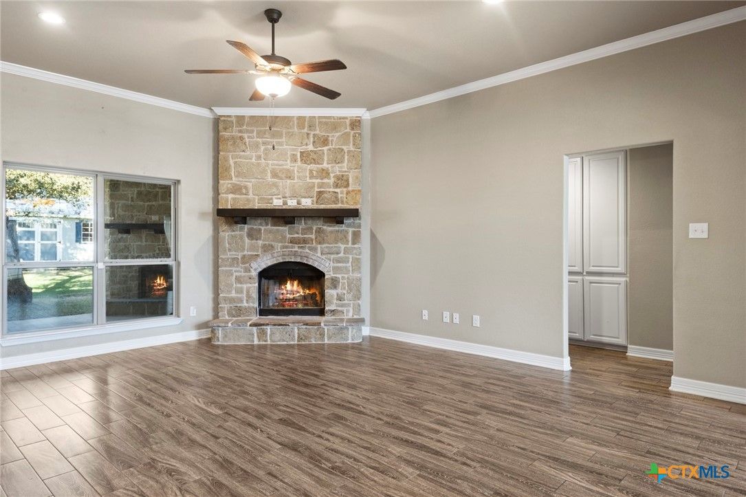 Empty room, Fireplace, Interior, Recessed Lighting, Stone Walls, Wood Texture Flooring