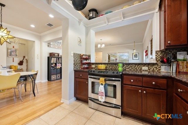 Chandelier, Dining room, Interior, Kitchen, Pendant Lights, Recessed Lighting, Stainless Steel Appliances, Wood Texture Flooring